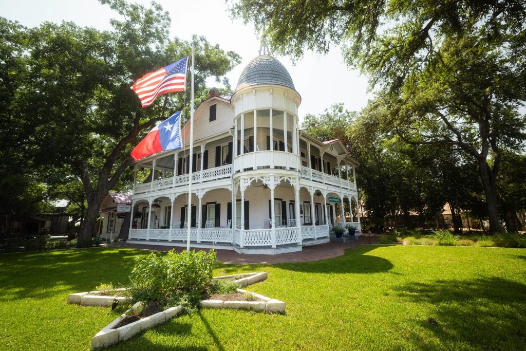 Gruene Mansion Inn with American flag and Texas flag